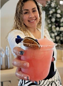 Guest holding a Frost Social frozen mocktail